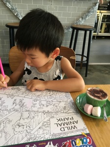 Busy with his search and find colouring activity